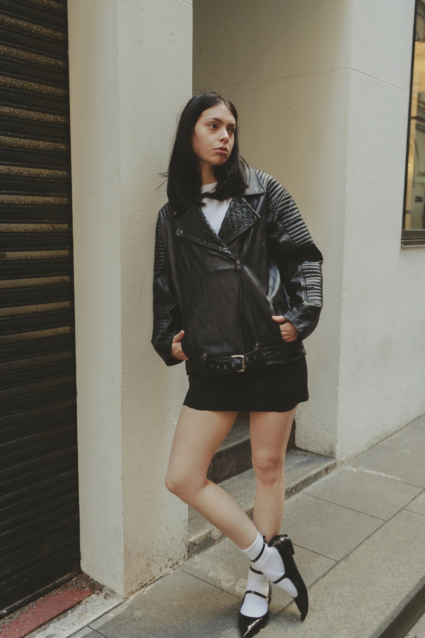 Girl wearing Qara Jacket in black eco leather featuring quilted shoulders and moto-inspired stitching, styled in New York City – a collectible fashion piece by My Paloma.