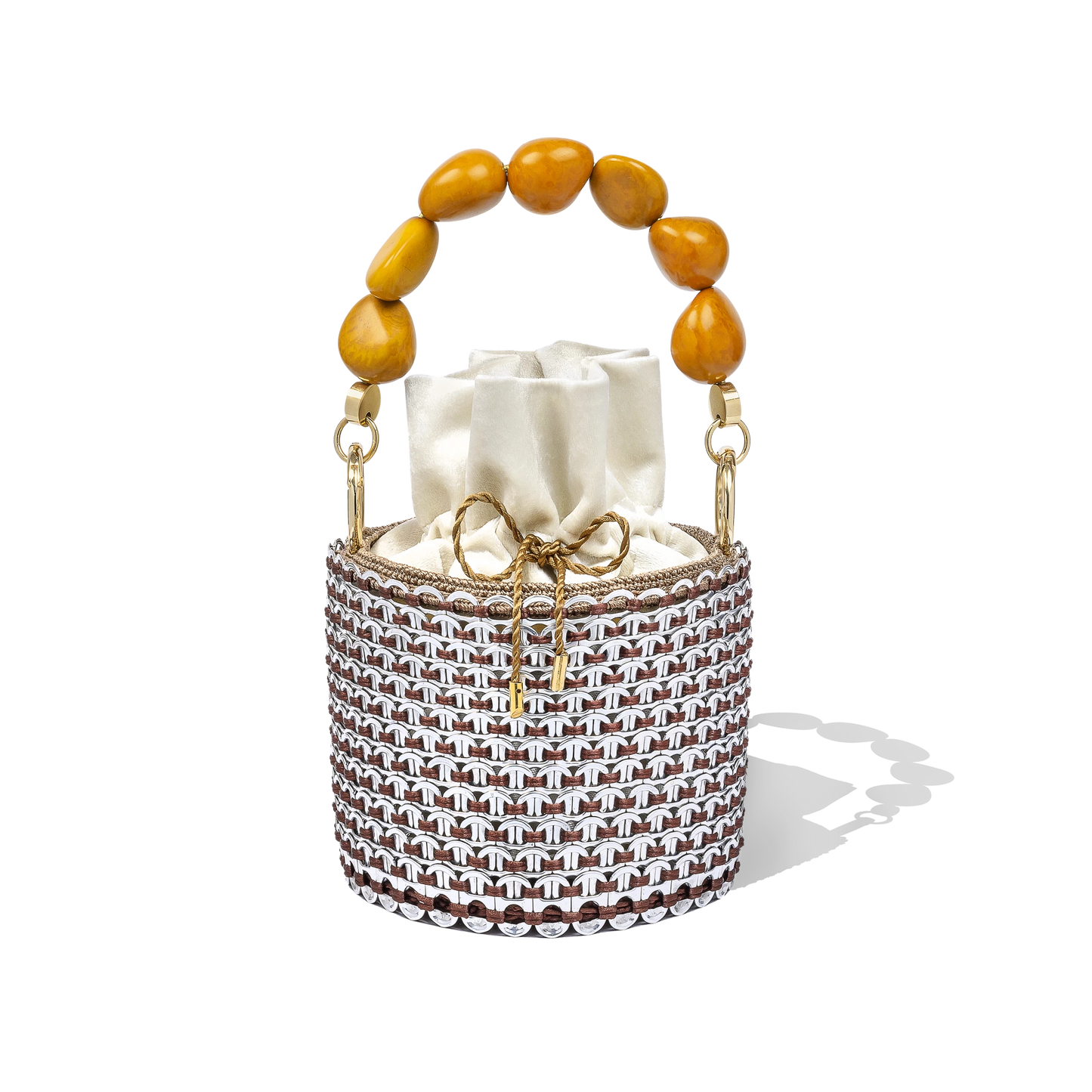 Alex Bucket Bag with clear crystal mesh body, amber beaded handle, and ivory drawstring pouch insert displayed on a white backdrop.