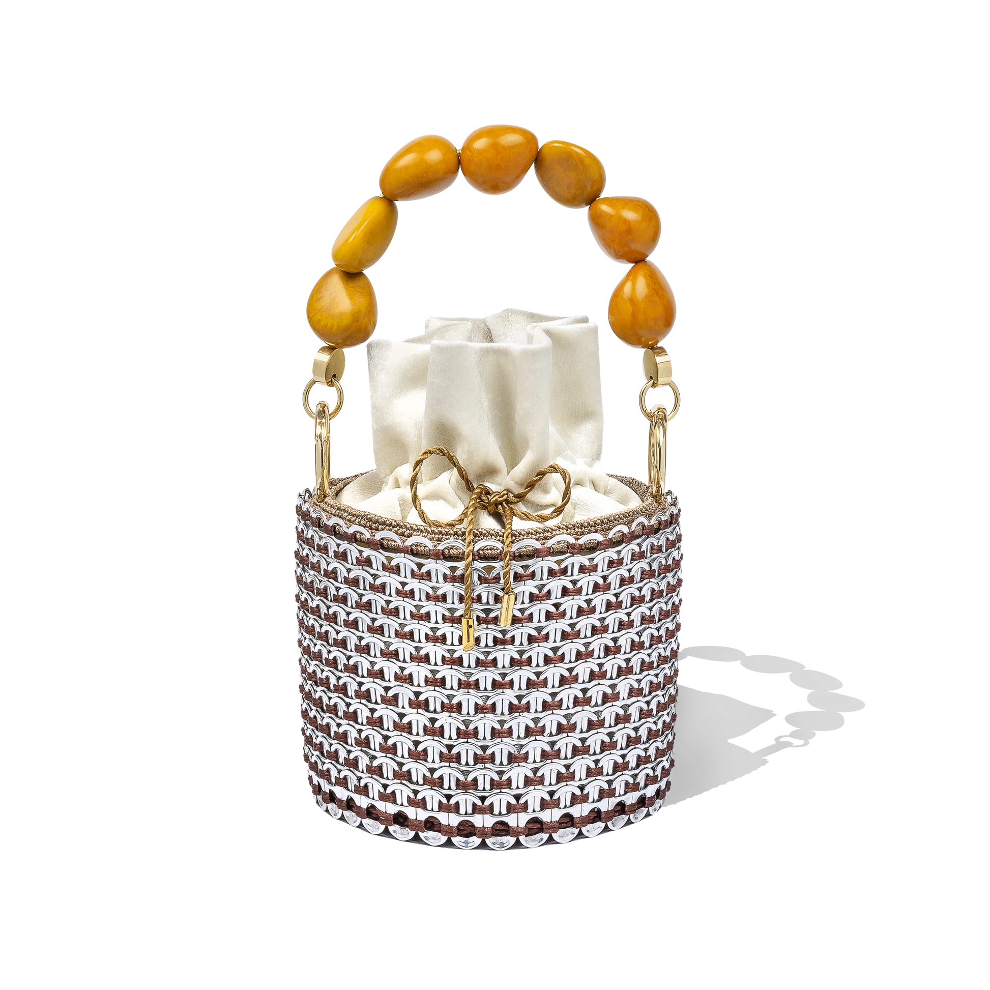 Alex Bucket Bag with clear crystal mesh body, amber beaded handle, and ivory drawstring pouch insert displayed on a white backdrop.