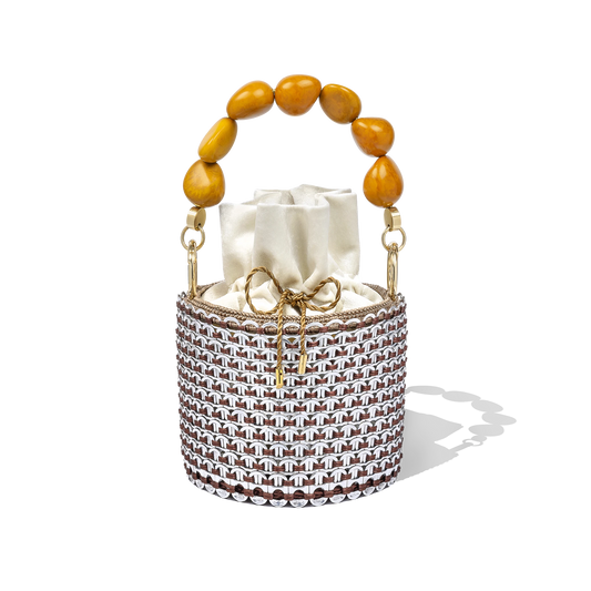 Alex Bucket Bag with clear crystal mesh body, amber beaded handle, and ivory drawstring pouch insert displayed on a white backdrop.