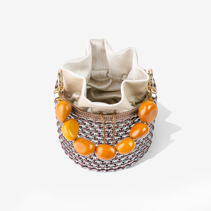 Rear view of the Alex Bucket Bag featuring crystal mesh texture, bold beaded handle, and a peek of the internal drawstring pouch closure.