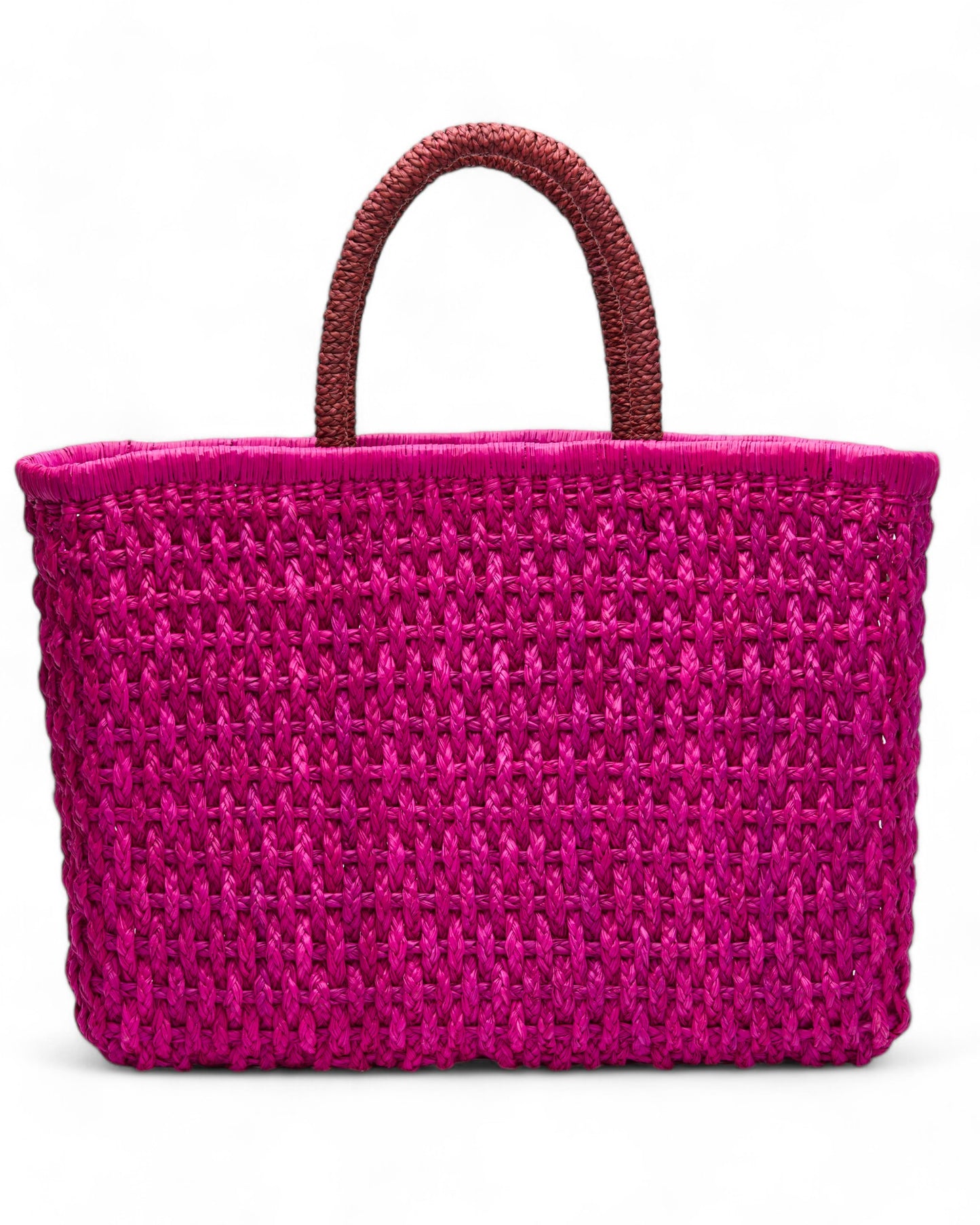Side-angle view of the Viva Tote highlighting the depth of the bag, texture of the straw weave, and sturdy hand-braided handles.