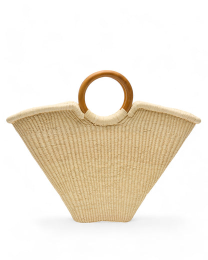 Angled view of the Verano Tote placed upright, showcasing its spacious, unlined interior and strong wooden handles against a plain backdrop.