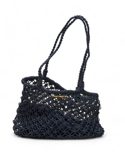Hand-crocheted navy Sapphire Moon Clutch displayed against a white background, featuring dual looped handles and a soft, flexible shape.