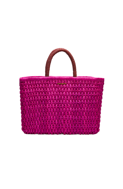 Front-facing flat lay of the Viva Tote, handwoven in bright magenta toquilla straw with dual dark currant handles and a structured rectangular shape.