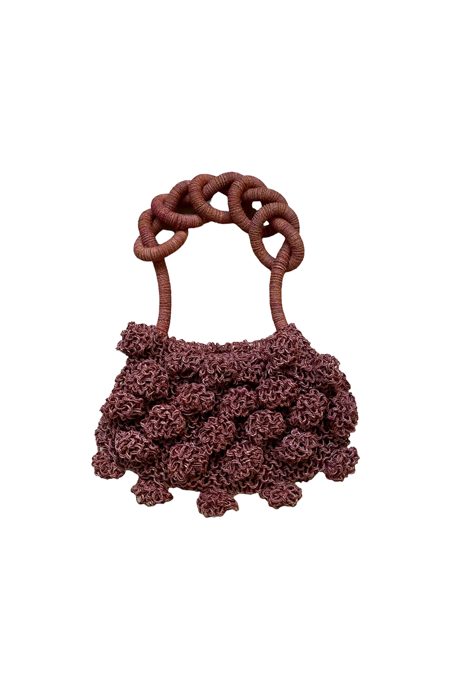 Macro close-up of the crochet craftsmanship on the burgundy Ameba Mesh Bag, showing intricate looping and texture.