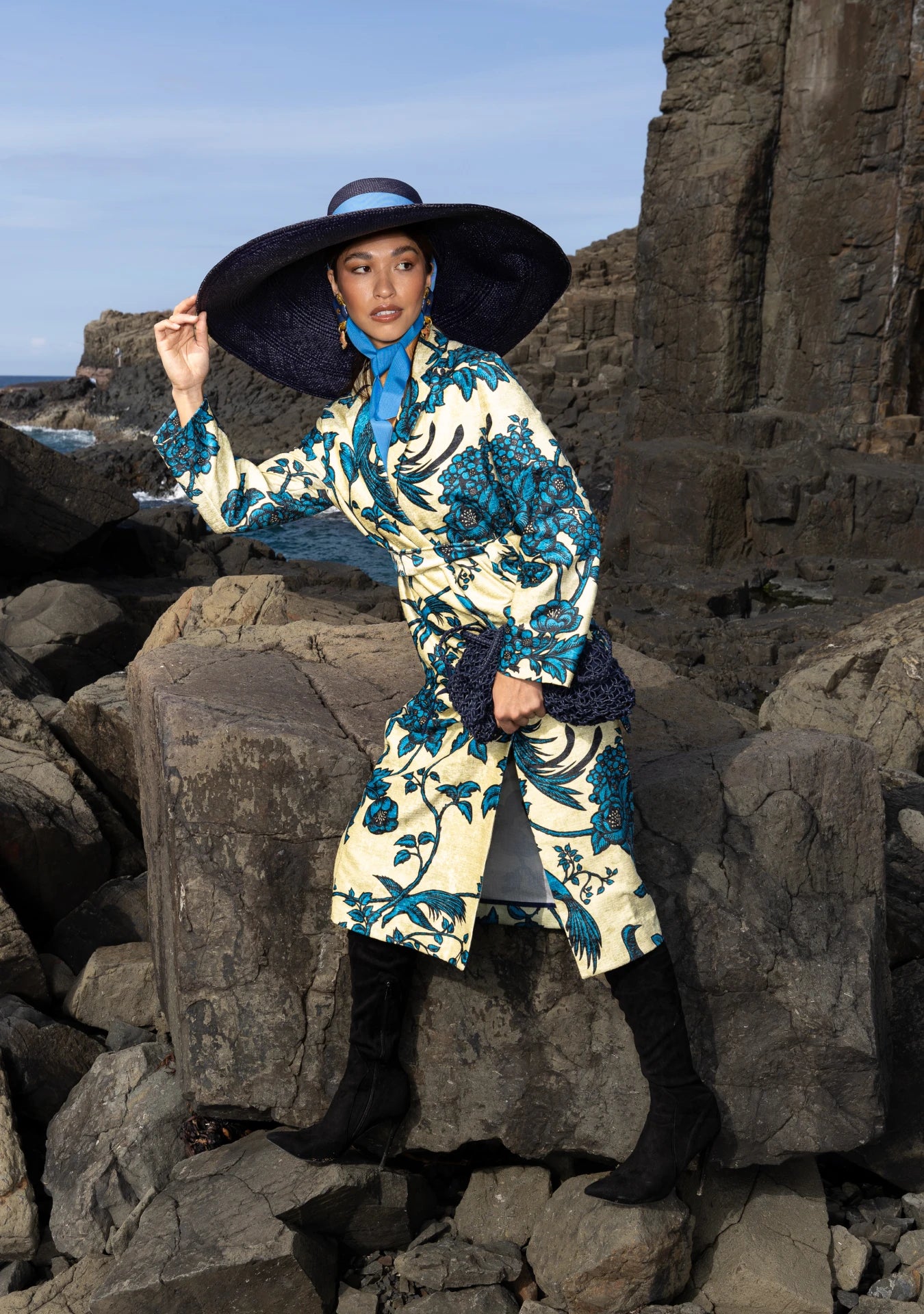 Model wearing the Birds of Paradise Coat with signature turquoise birds on flax base, styled in Barcelona, Spain – limited edition outerwear by My Paloma.
