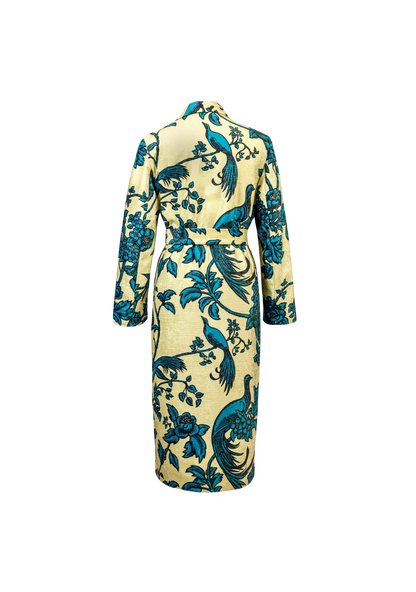 Back view of the Birds of Paradise Coat with signature turquoise birds on flax base, styled in Barcelona, Spain – limited edition outerwear by My Paloma.