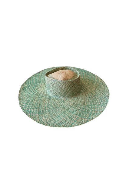 Top-down view of the Chalan Sunhat in Surf Marino showing the wide circular brim and central dome in natural palm fibre—blended with turquoise weave for a coastal-luxe aesthetic.