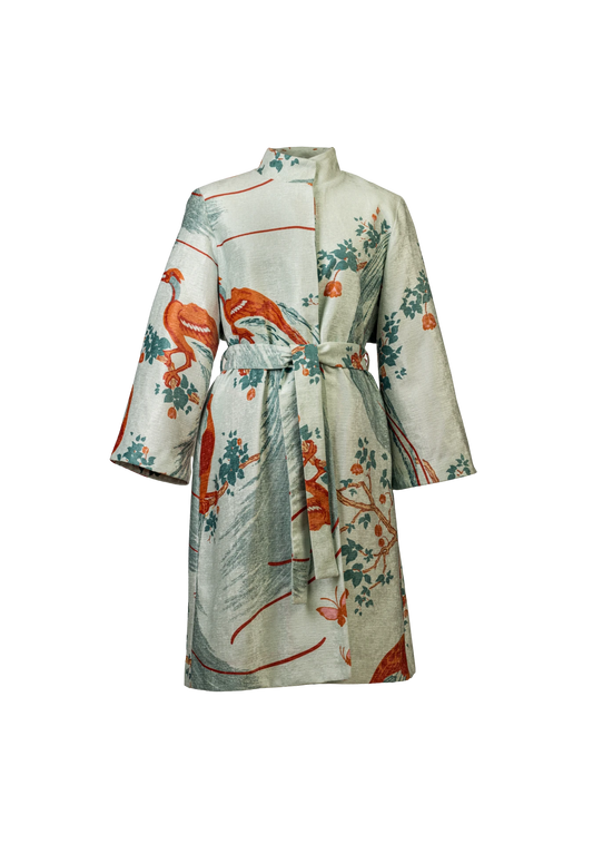 Front view of the Exotic Birds Coat with rust and mint illustrations, photographed in Amsterdam, Netherlands – cross-cultural fashion by My Paloma.