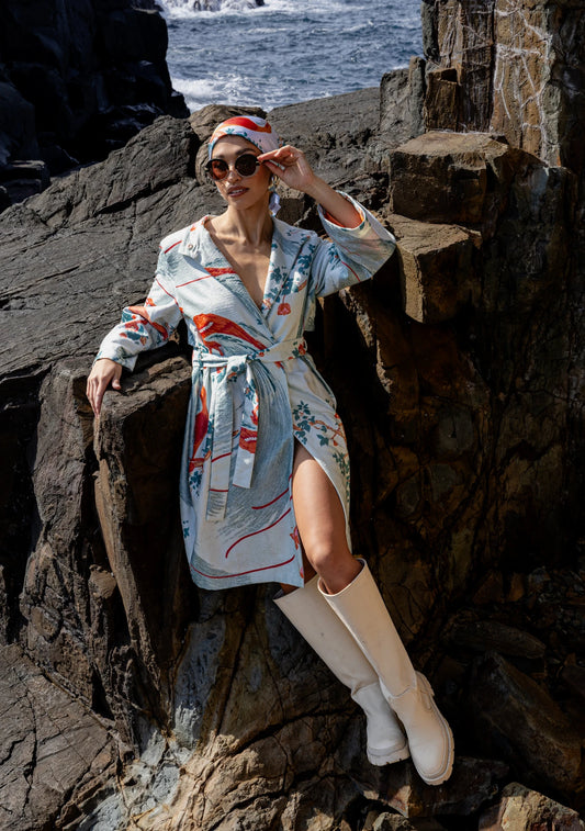 Model wearing the Exotic Birds Coat with rust and mint illustrations, photographed in Amsterdam, Netherlands – cross-cultural fashion by My Paloma.  