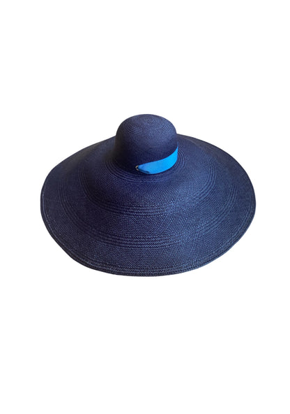Lady Ibiza Hat in midnight navy, shown from above to feature its dramatic wave-like brim and sculptural crown—finished with tonal ribbon ties for an elegant, minimalist silhouette.