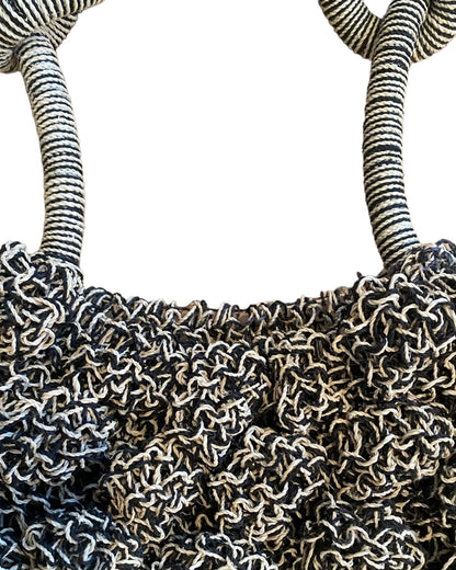 Close-up of the grey Ameba Mesh Bag catching natural sunlight, highlighting texture and craftsmanship.