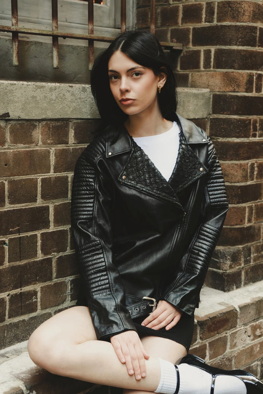 the Qara Jacket in black eco leather featuring quilted shoulders and moto-inspired stitching, styled in New York City – a collectible fashion piece by My Paloma.