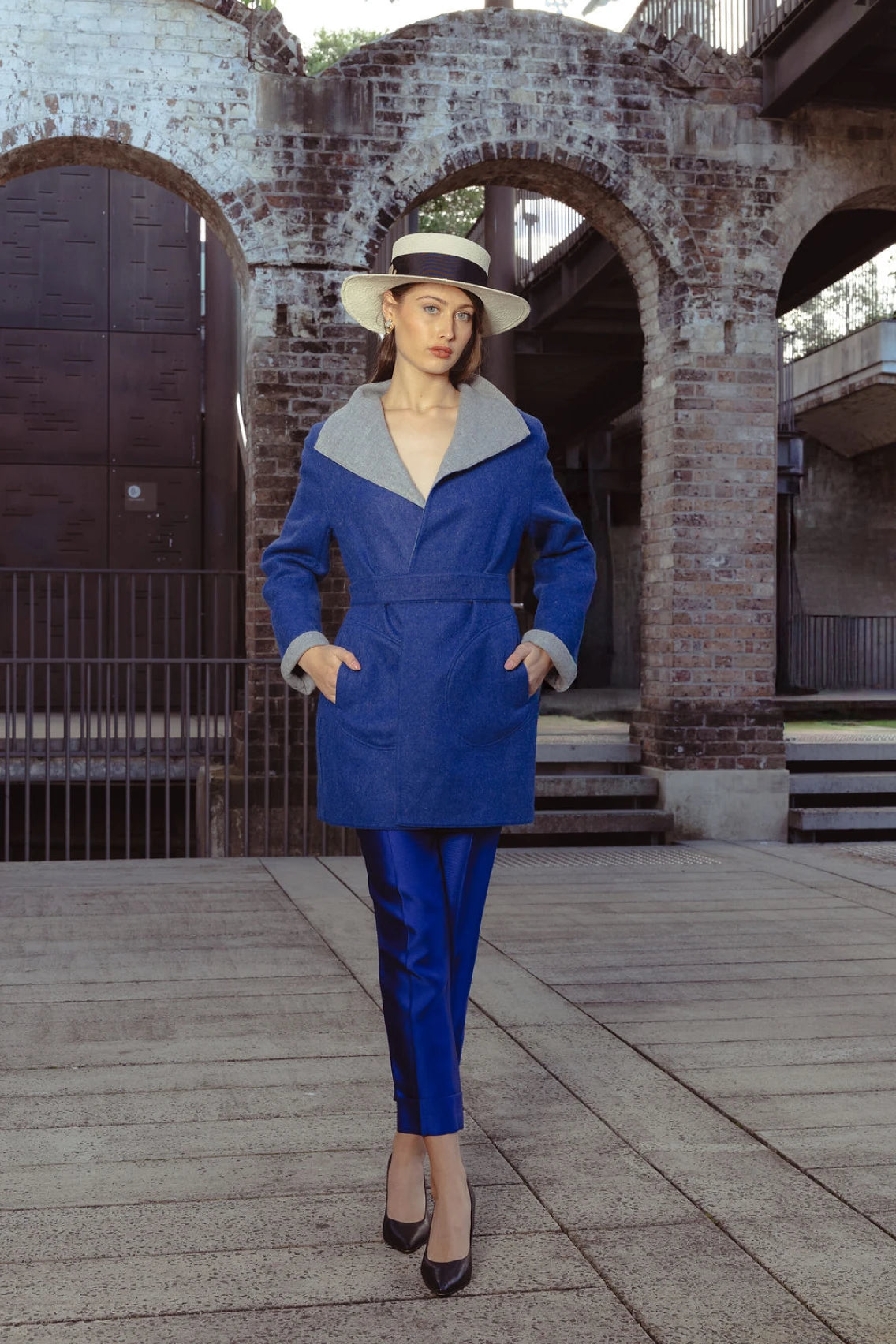 Beautiful girl wearing the blue/grey reversible Soho Coat in rich indigo alpaca blend, shot in San Francisco, USA – combining comfort and craft by My Paloma. Made from Alpaca wool