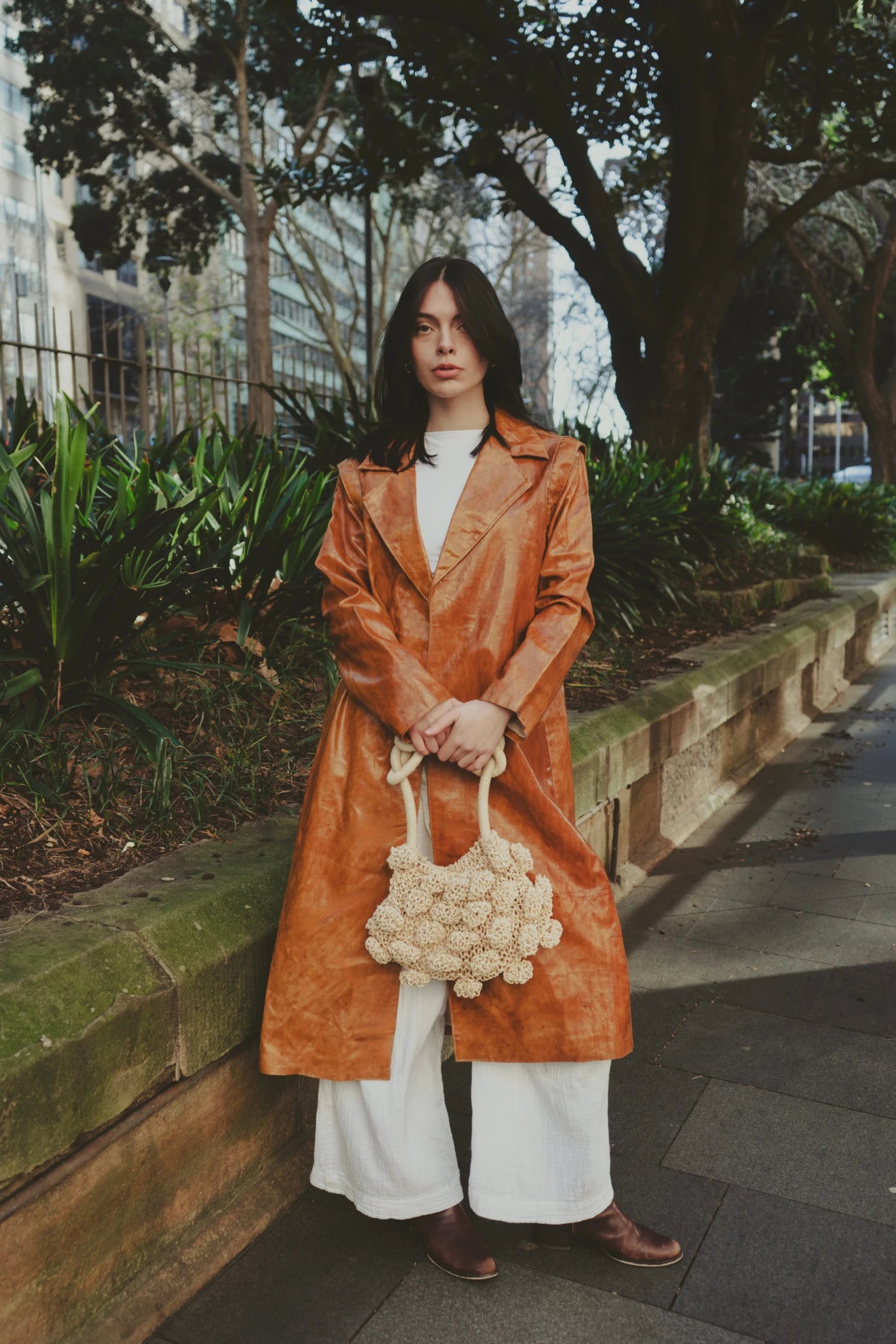 Girl wearing Sauce Coat with minimalist cut and warm caramel hue, photographed in Paris, France – a slow fashion essential from My Paloma.