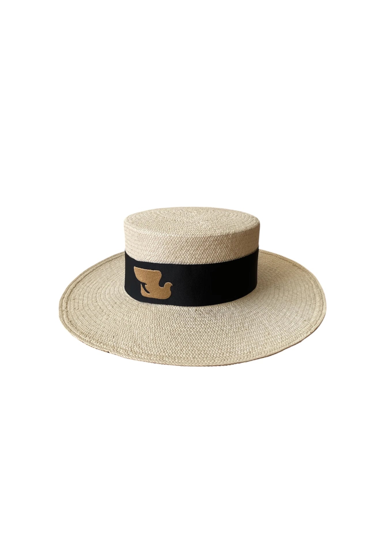 Front-angled product image of the Wayra Hat featuring a flat crown and wide brim, finished with a thick black ribbon and embroidered dove motif—crafted from natural straw for structured luxury.