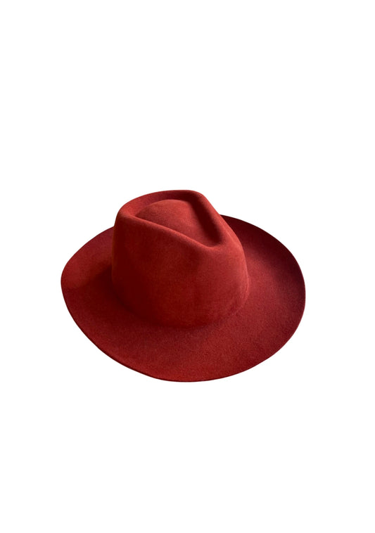 Brick red wool-felt fedora hat with a wide brim and classic pinched crown, displayed on a white background