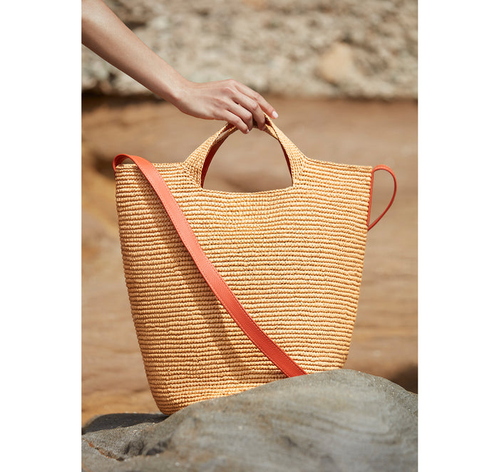 Tall bag with orange leather strap